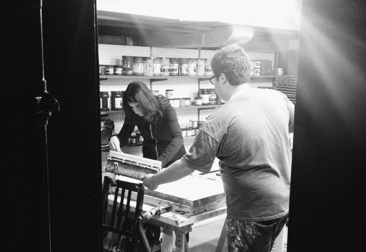 Christina and Dennis Jacobs screen printing in their basement studio, located in their home near Detroit, Michigan