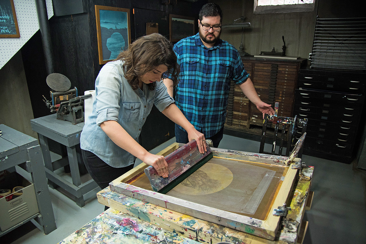 Artists Christina and Dennis Jacobs screen printing in their home studio near Detroit, Michigan